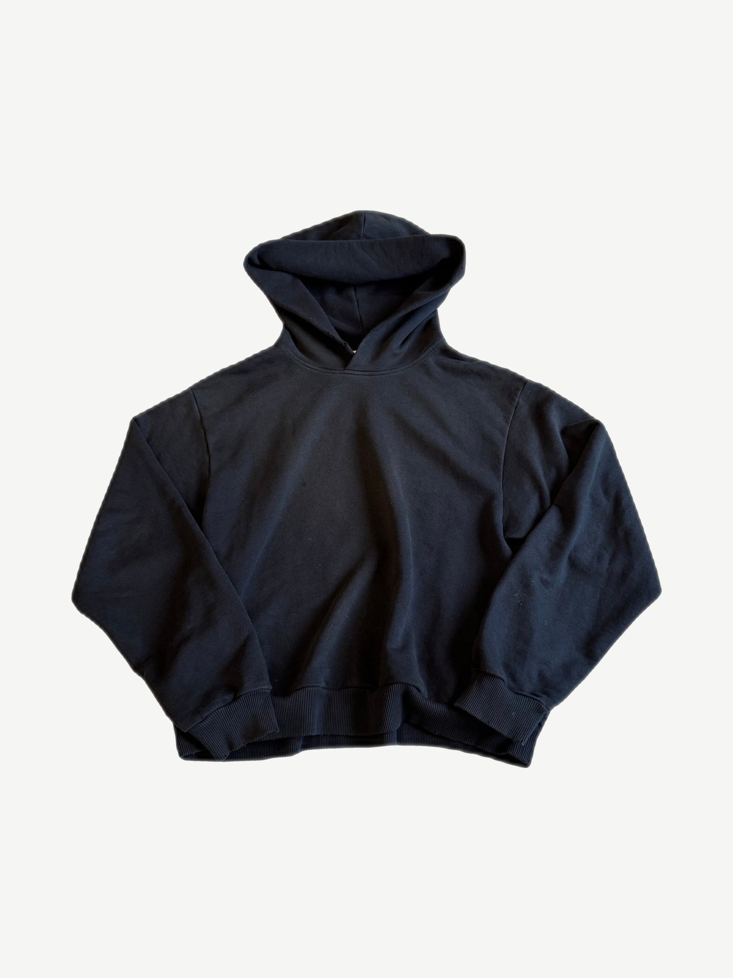 Acne Studios black fleece hoodie with relaxed boxy silhouette, oversized hood and ribbed cuffs.