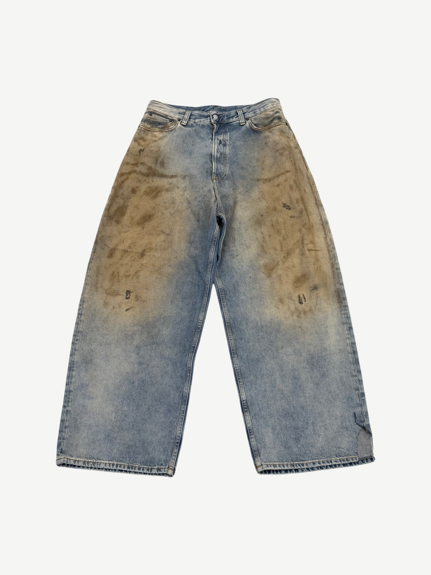 Acne Studios Penicillin baggy jeans front view in light blue denim with brown mud-wash front thigh staining