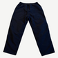 Back of Balenciaga 3B Sports Icon black tracksuit pants showing straight-leg silhouette and elastic waist