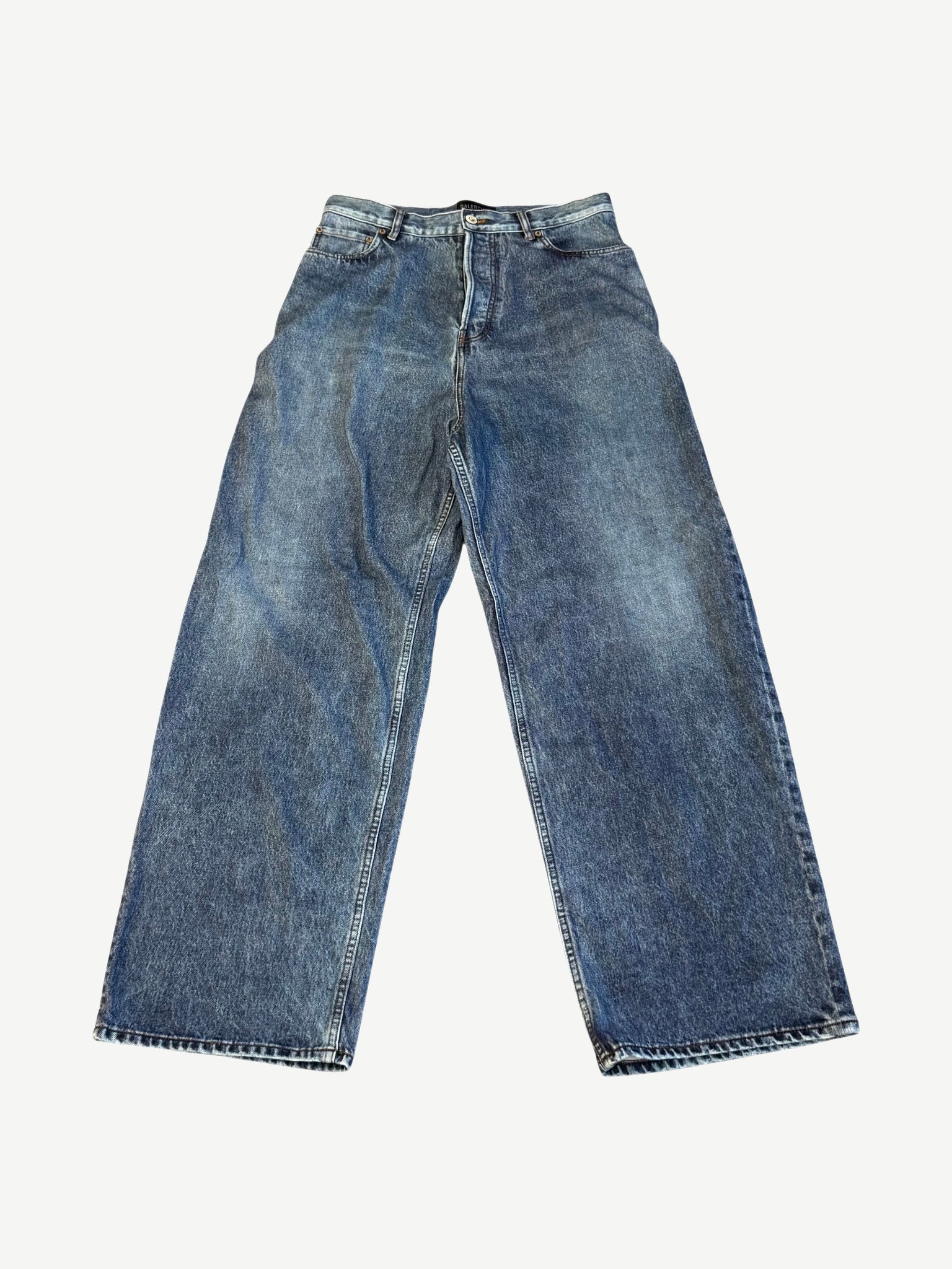 Balenciaga baggy trompe l'oeil jeans front view in mid wash blue denim with wide leg silhouette