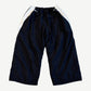 Balenciaga black 3B Sports Icon trackpants back view, baggy nylon with curved white side panels at hip