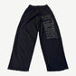 Balenciaga Agaicnelab black baggy sweatpants back view with tonal vertical logo print on leg