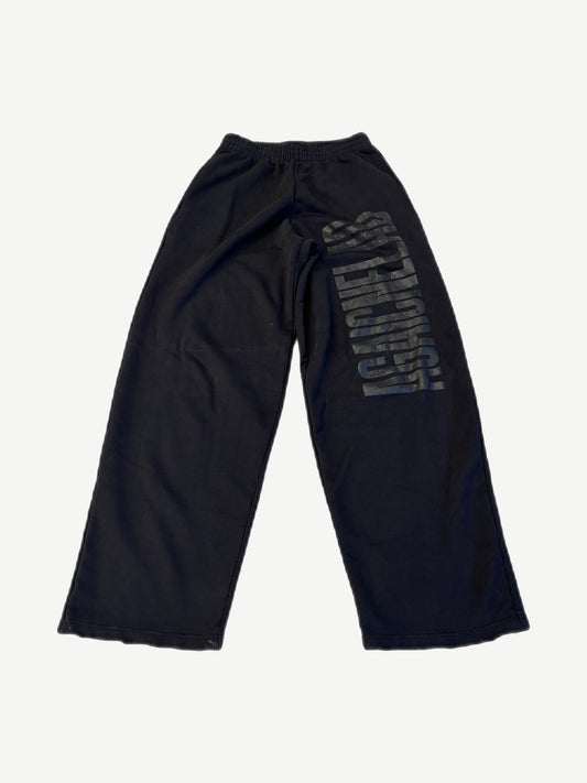 Balenciaga Agaicnelab black baggy sweatpants back view with tonal vertical logo print on leg