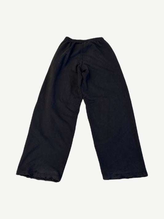 Balenciaga black baggy sweatpants back plain view with distressed raw hem detail
