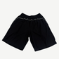 Balenciaga black soccer shorts back view, plain panel with elastic drawstring waistband and side seam detail
