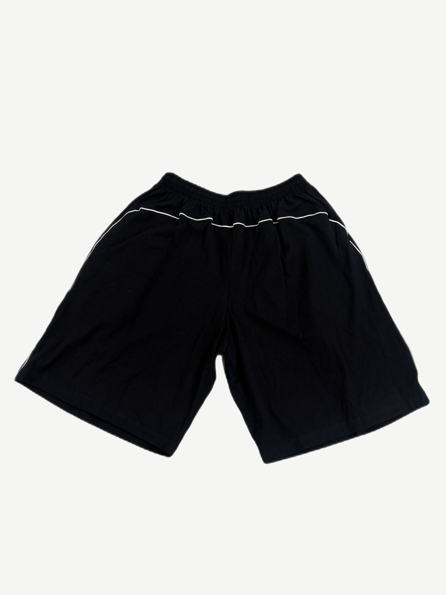 Balenciaga black soccer shorts back view, plain panel with elastic drawstring waistband and side seam detail