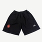 Balenciaga black athletic soccer shorts with white embroidered crest logo on left thigh, front view