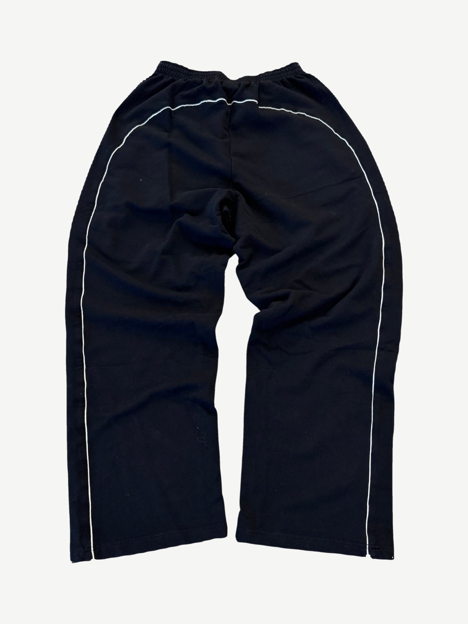 Balenciaga soccer crest sweatpants back view with white side piping running the length of each leg seam.