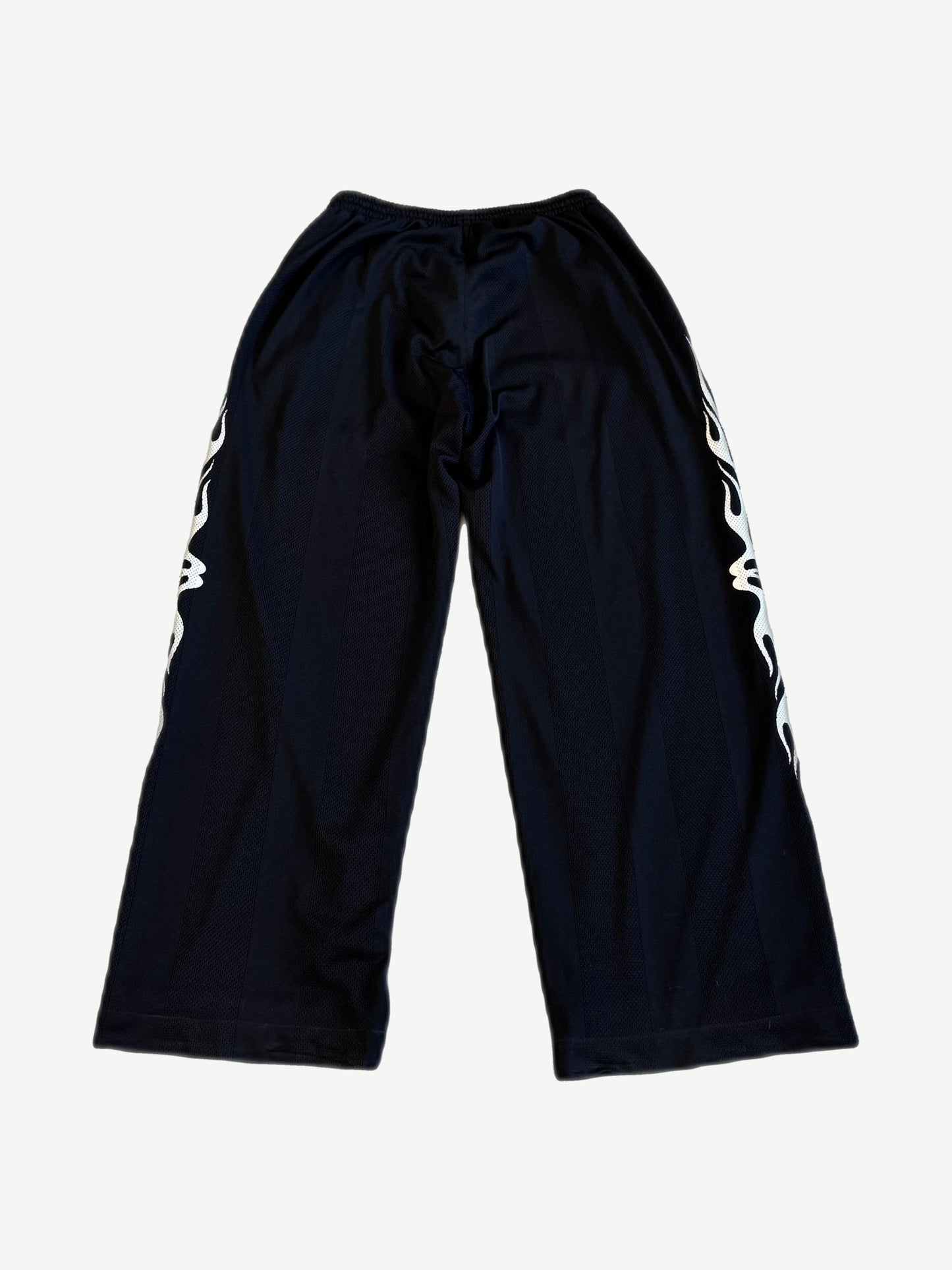 Balenciaga Burning Unity black mesh pants back view with mirrored tribal flame leg graphics