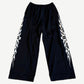 Balenciaga Burning Unity wide-leg black mesh pants with white tribal flame side panel print
