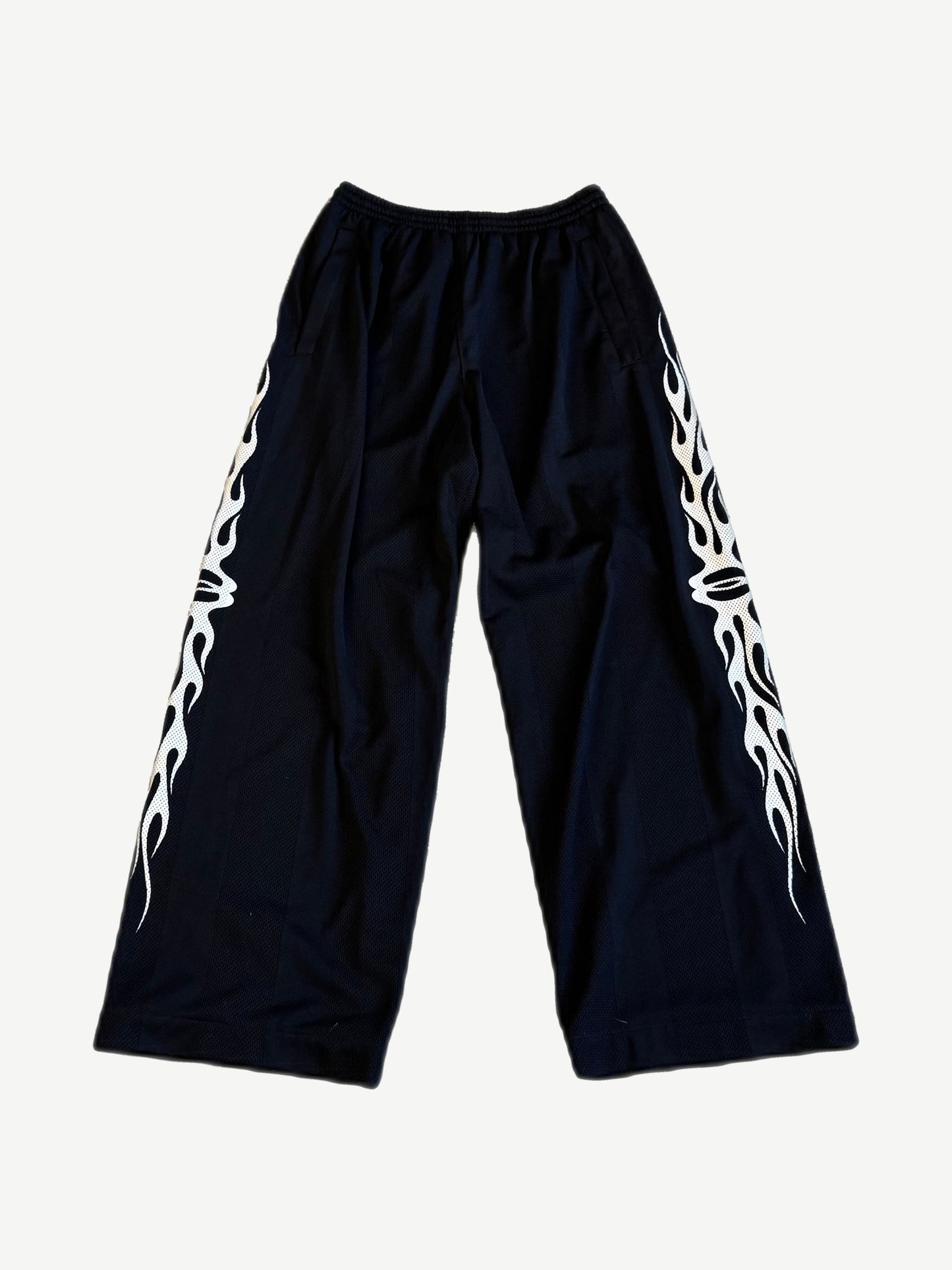 Balenciaga Burning Unity wide-leg black mesh pants with white tribal flame side panel print
