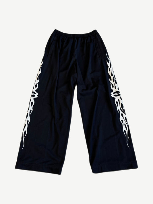 Balenciaga Burning Unity wide-leg black mesh pants with white tribal flame side panel print