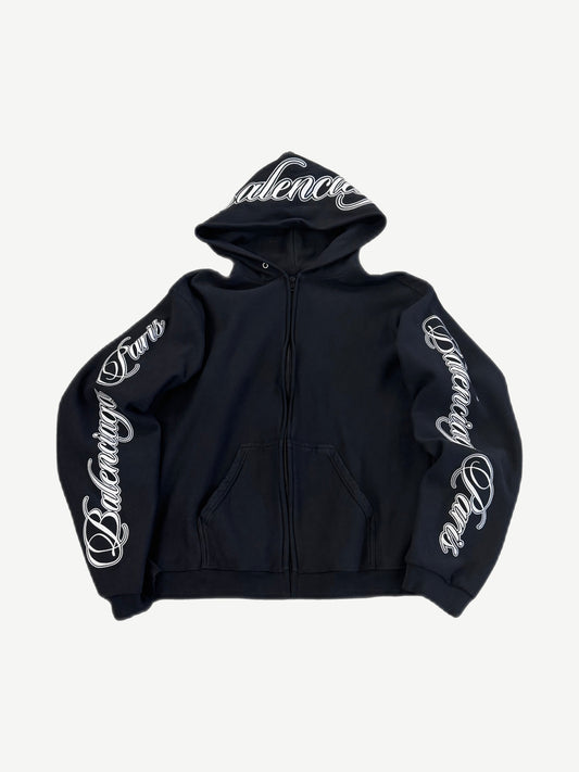 Balenciaga black zip hoodie front with white cursive Balenciaga logo on hood and down both sleeves