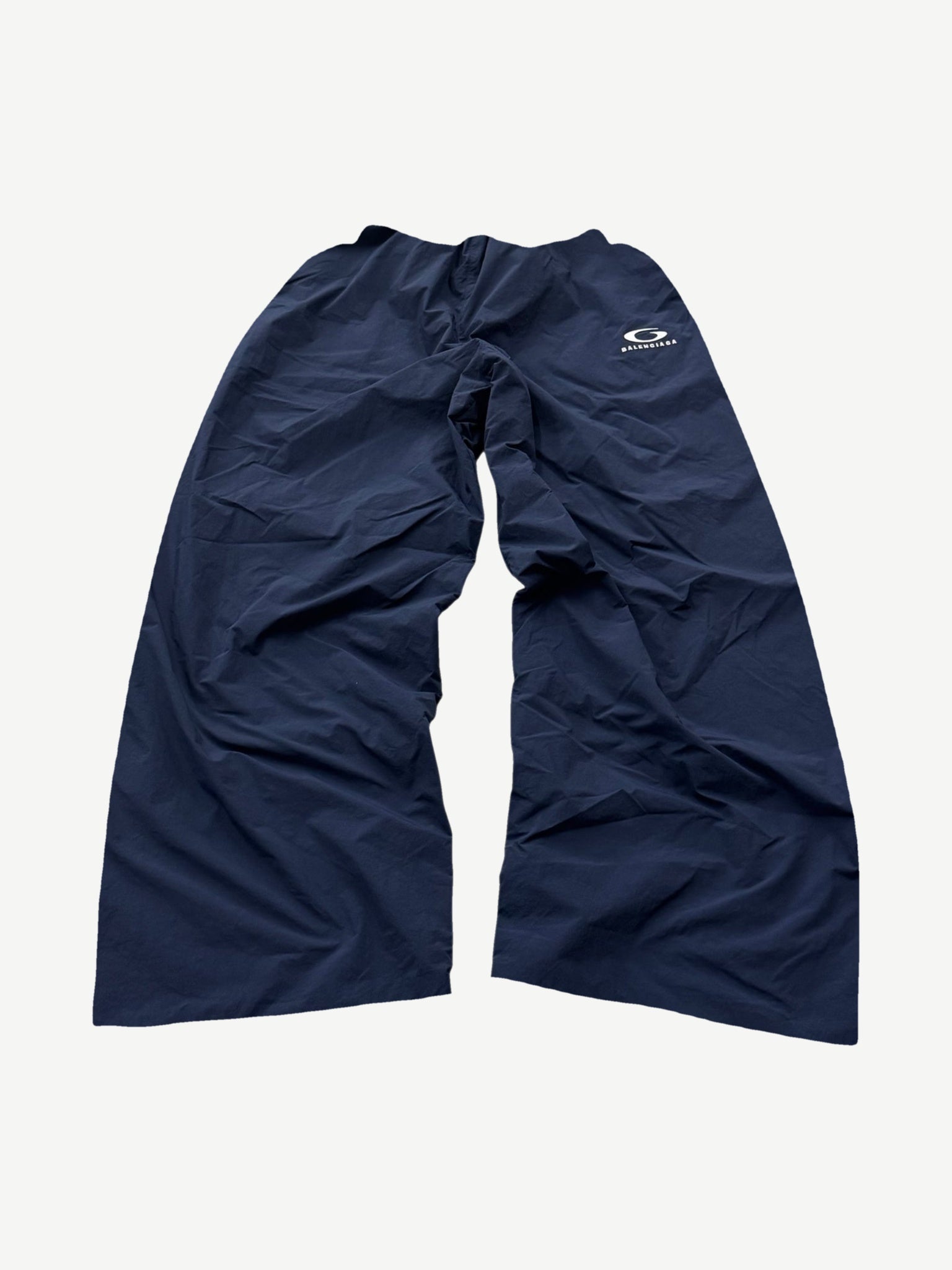 Balenciaga navy Loop Sports Icon trackpants with white side stripe and tonal logo at hip, front view