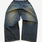 Balenciaga waxed baggy blue jeans with glossy coated finish, five-pocket cut and wide loose leg.