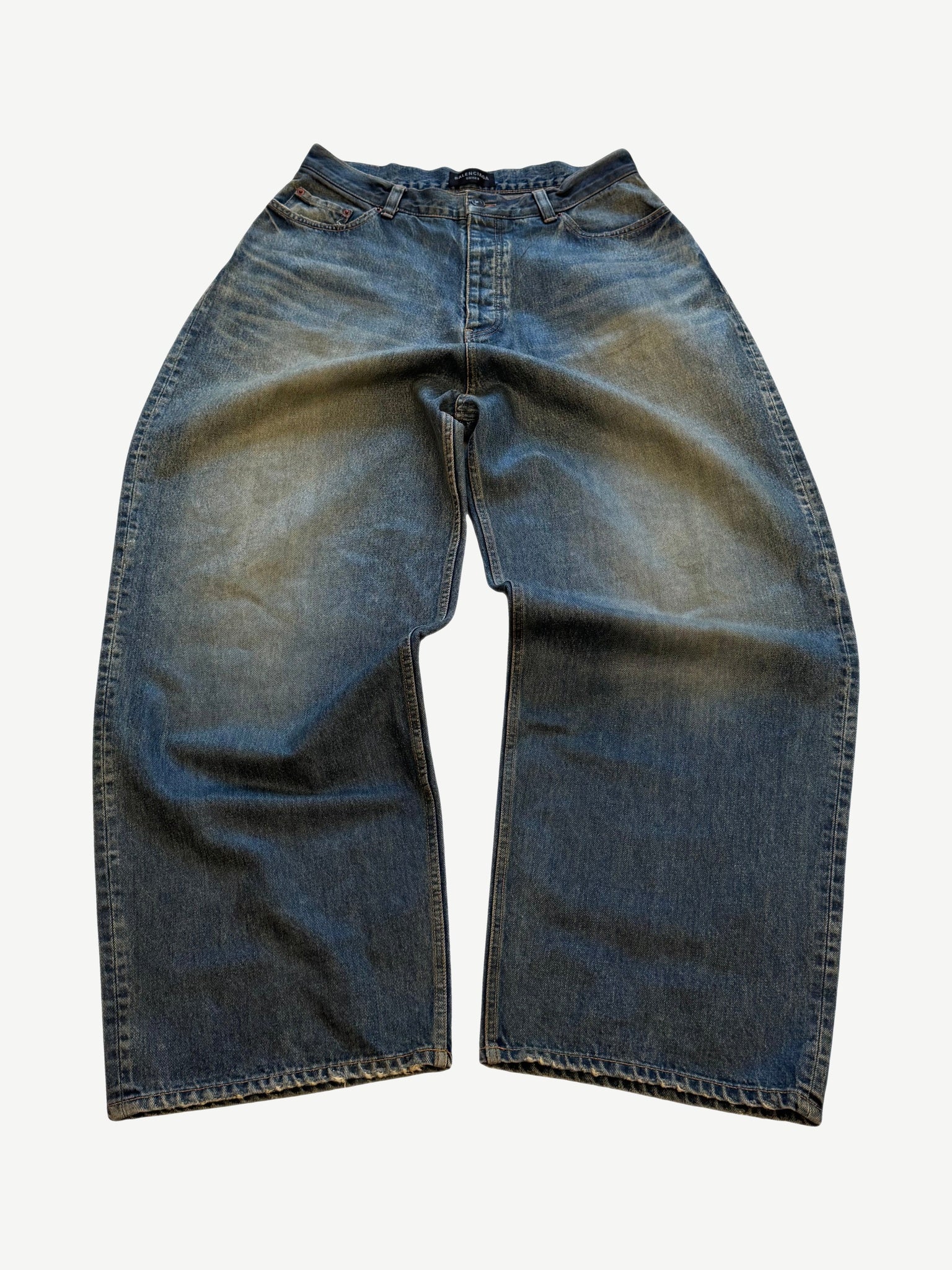 Balenciaga waxed baggy blue jeans with glossy coated finish, five-pocket cut and wide loose leg.