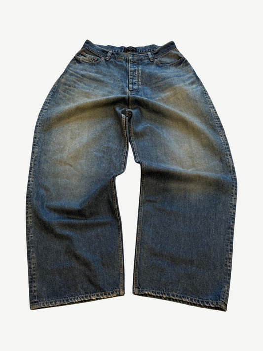 Balenciaga waxed baggy blue jeans with glossy coated finish, five-pocket cut and wide loose leg.