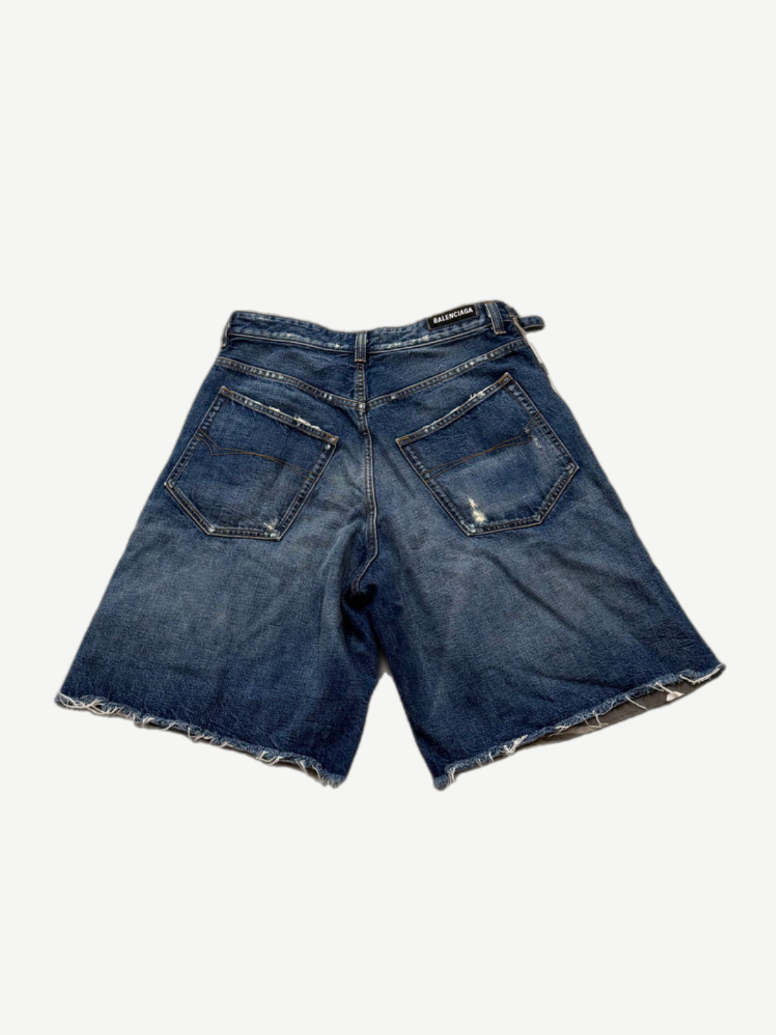 Balenciaga washed denim cargo shorts back view with five-pocket cut and raw frayed cutoff hem