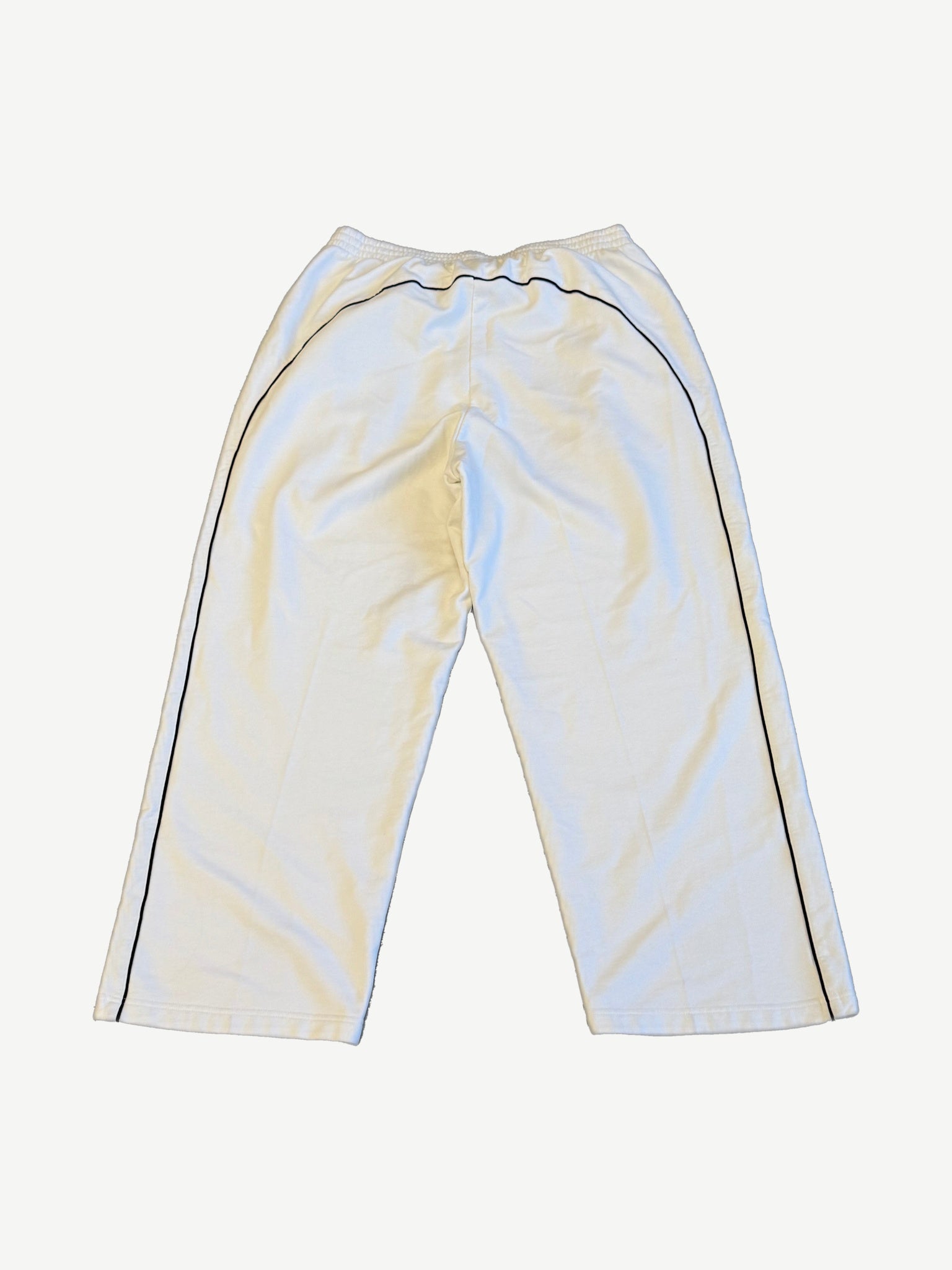 Balenciaga white soccer crest sweatpants back view with elastic waistband and straight leg fleece silhouette