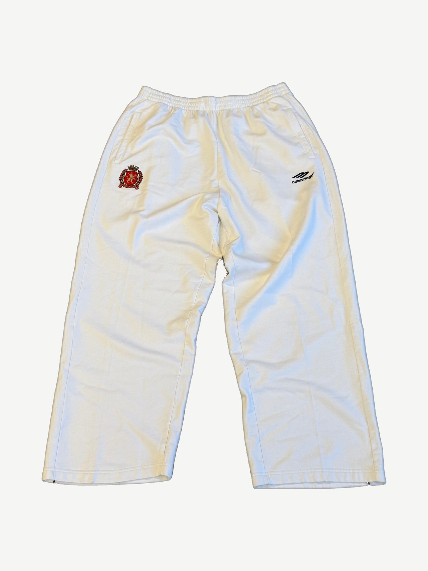 Balenciaga white cotton sweatpants with embroidered red lion soccer crest and Balenciaga wing logo on hip