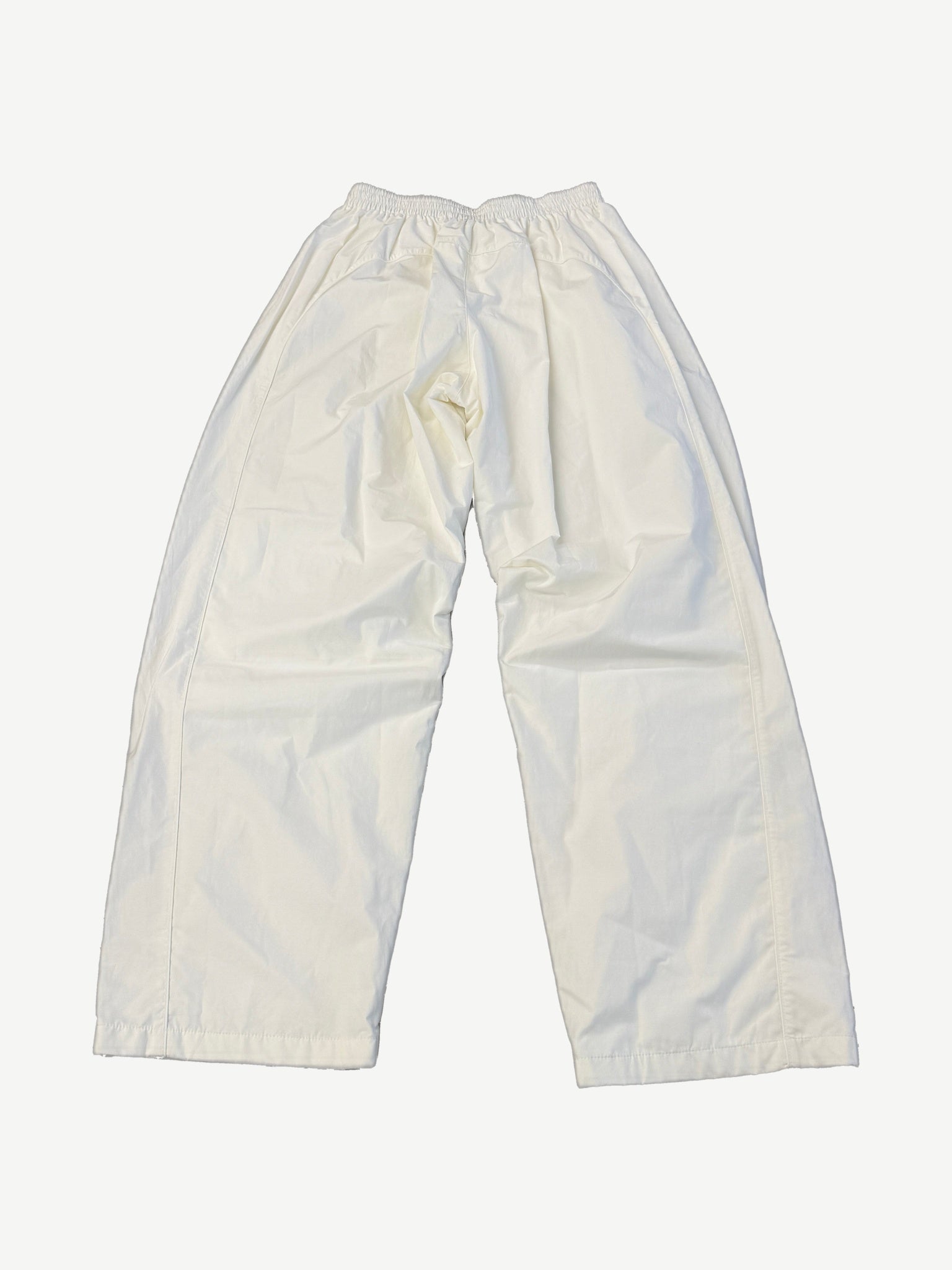 Balenciaga white soccer crest trackpants back view with relaxed wide leg cut and clean tonal stitching.