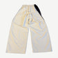 Balenciaga white tracksuit pants back view showing wide leg drape and contrast black side panel.