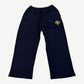 Balenciaga navy sweatpants with yellow circular Paris France crest logo on thigh and relaxed straight-leg fit.