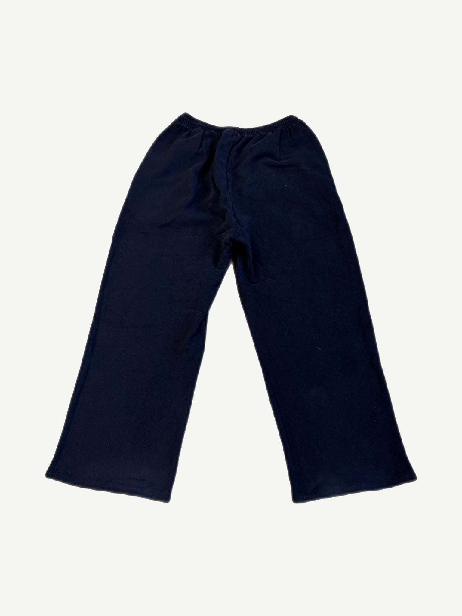 Balenciaga yellow crest logo sweatpants back view in dark navy fleece with elastic waistband and open hem cuffs.
