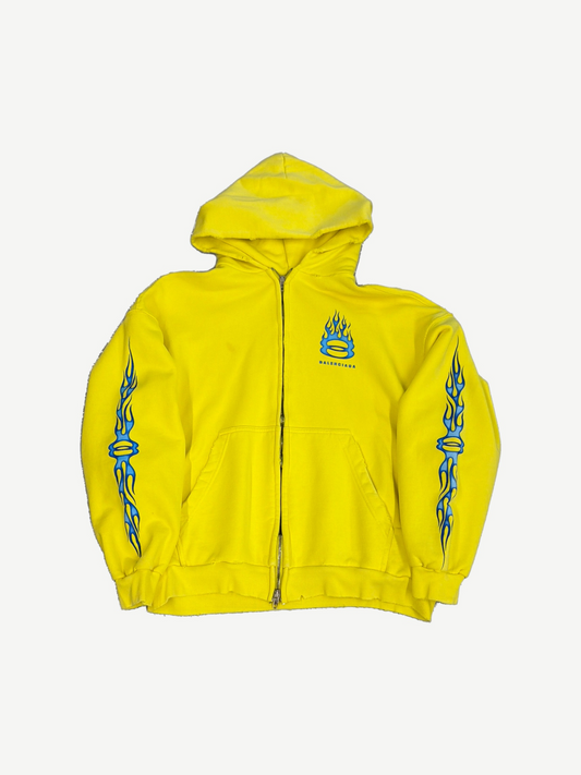 Balenciaga yellow Unity zip hoodie front, blue flame Unity ring logo on chest with blue flame sleeve prints.