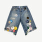 Better With Age denim jean shorts front view, raw frayed hem with scattered enamel pin details