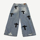 Back view of Bottega Desires blue Holy Grail jeans with leather rear patch and black embroidered cross logos
