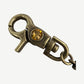 Bottega Desires brass wallet chain close-up of swivel lobster clasp set with a faceted amber crystal