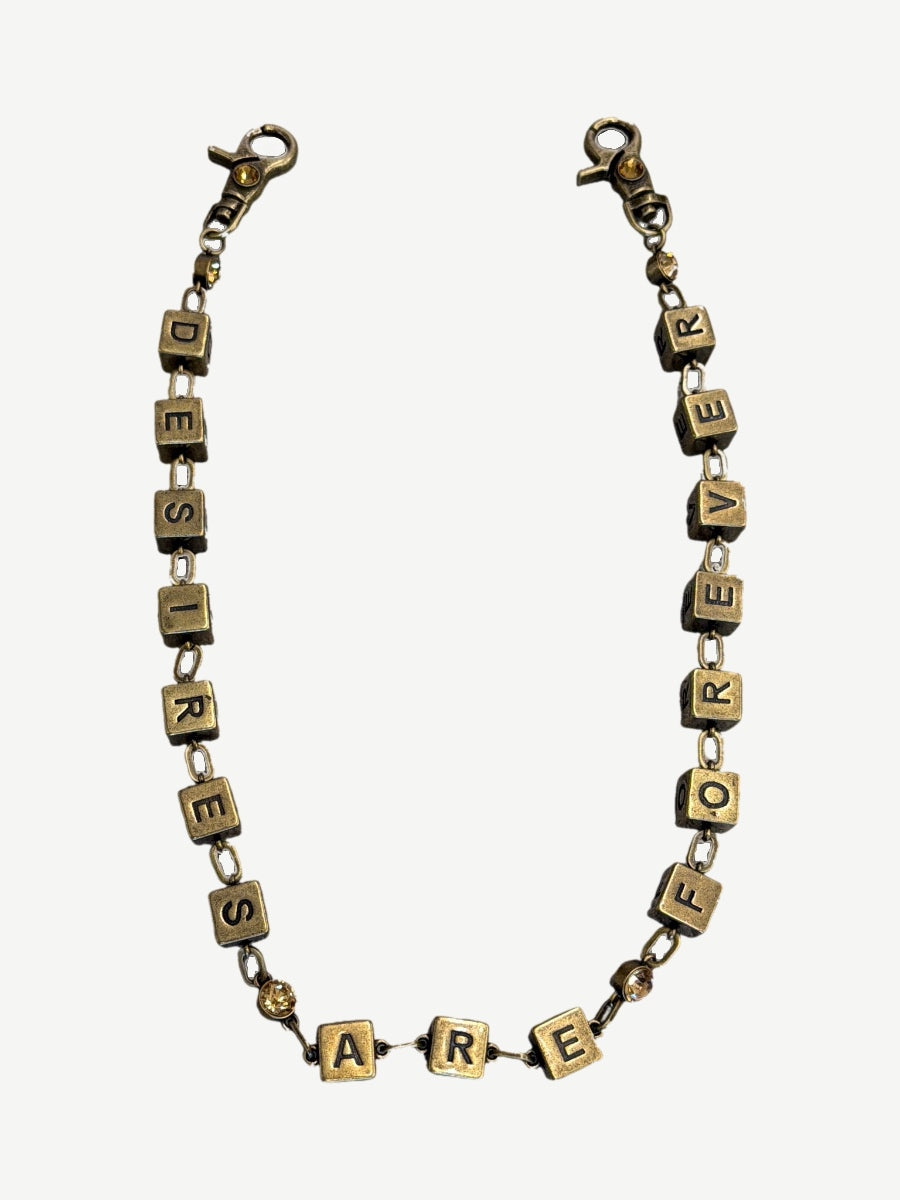 Bottega Desires brass wallet chain spelling Desires Are Forever in cube letter blocks with amber stone accents