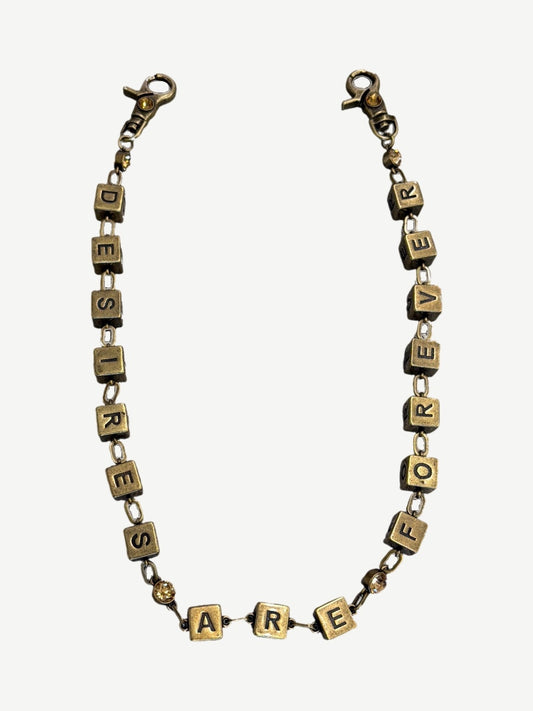 Bottega Desires brass wallet chain spelling Desires Are Forever in cube letter blocks with amber stone accents