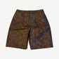 Bottega Desires brown leather shorts front view with arched Bottega Desires embroidery on distressed leather