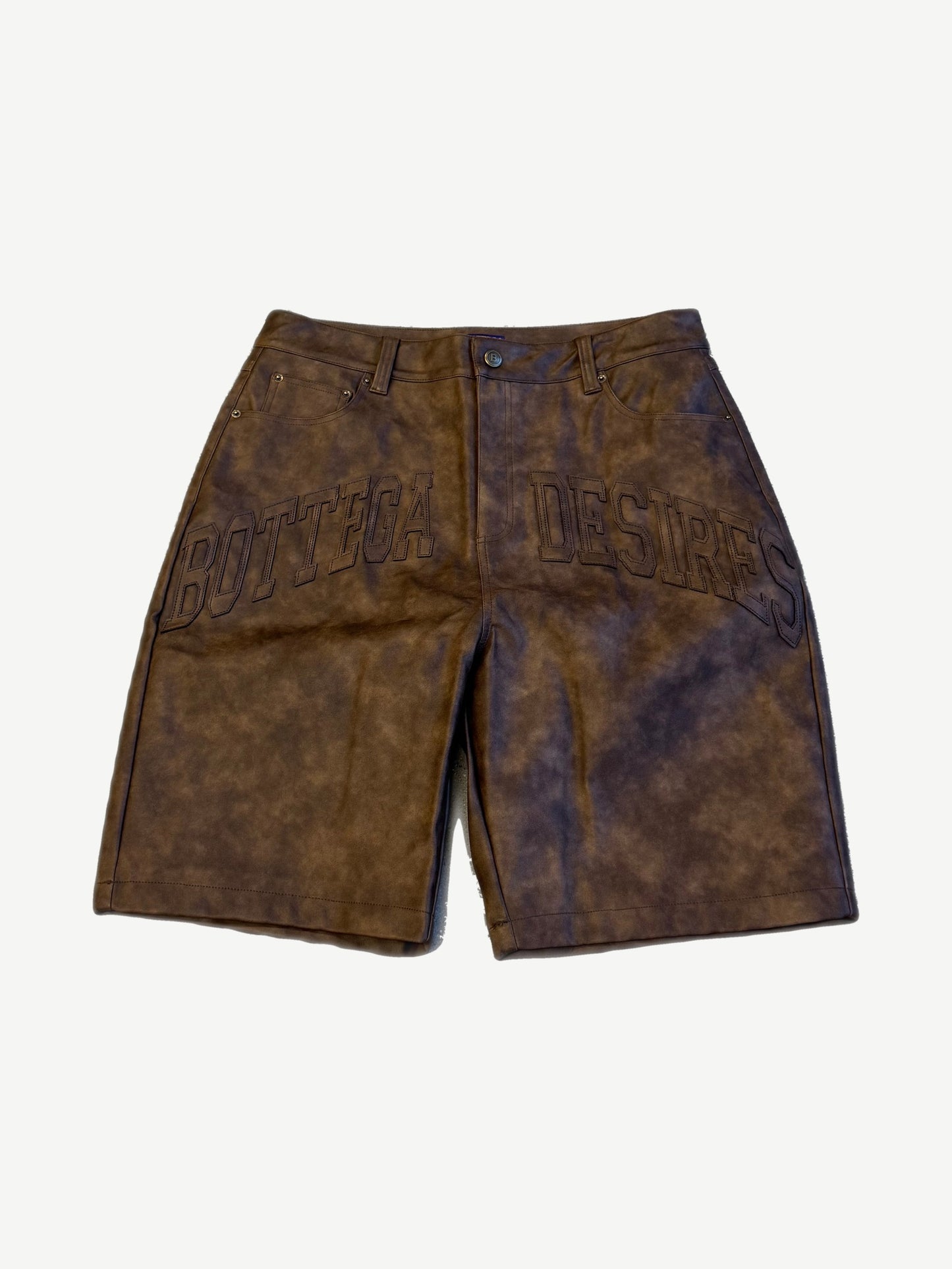 Bottega Desires brown leather shorts front view with arched Bottega Desires embroidery on distressed leather