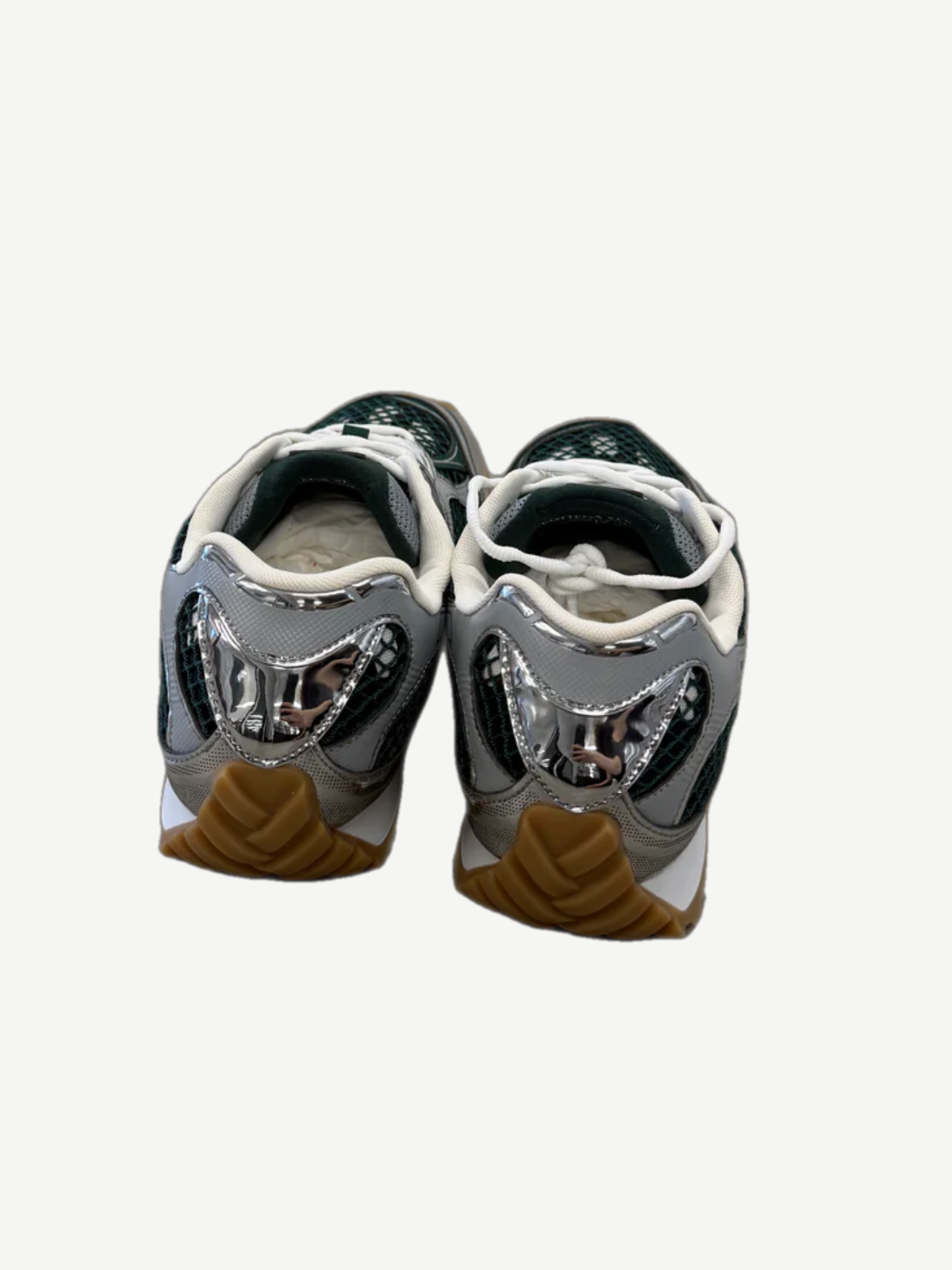 Bottega Veneta Orbit sneaker rear angle view showing sculpted silver heel cup and billiard green leather panels
