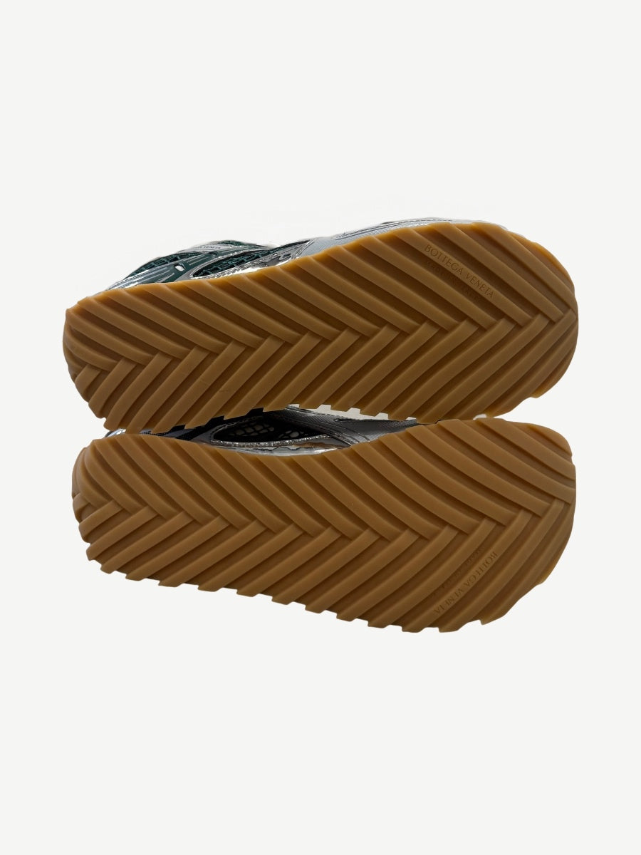 Bottega Veneta dark green Orbit sneakers angled pair view showing low-top silhouette and laces.