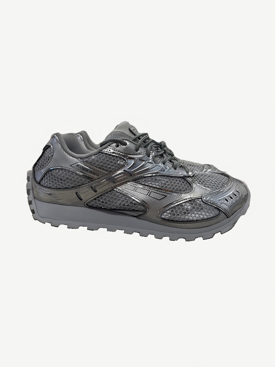 Bottega Veneta Orbit sneaker side profile in metallic silver with mesh panels and chunky lugged sole