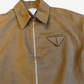 Bottega Veneta tan twill jacket close up showing triangle chest pocket emblem and silver zip detail