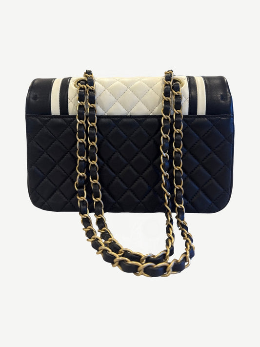 Back of Chanel Cosmopolite bicolor lambskin flap bag showing diamond quilted black leather and woven chain strap