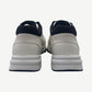 Chanel low top trainer back heel view showing black neoprene collar and white tumbled leather panel