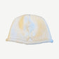 Chrome Hearts cream chunky knit beanie with tonal beaded cross emblem stitched to front and rolled cuff.