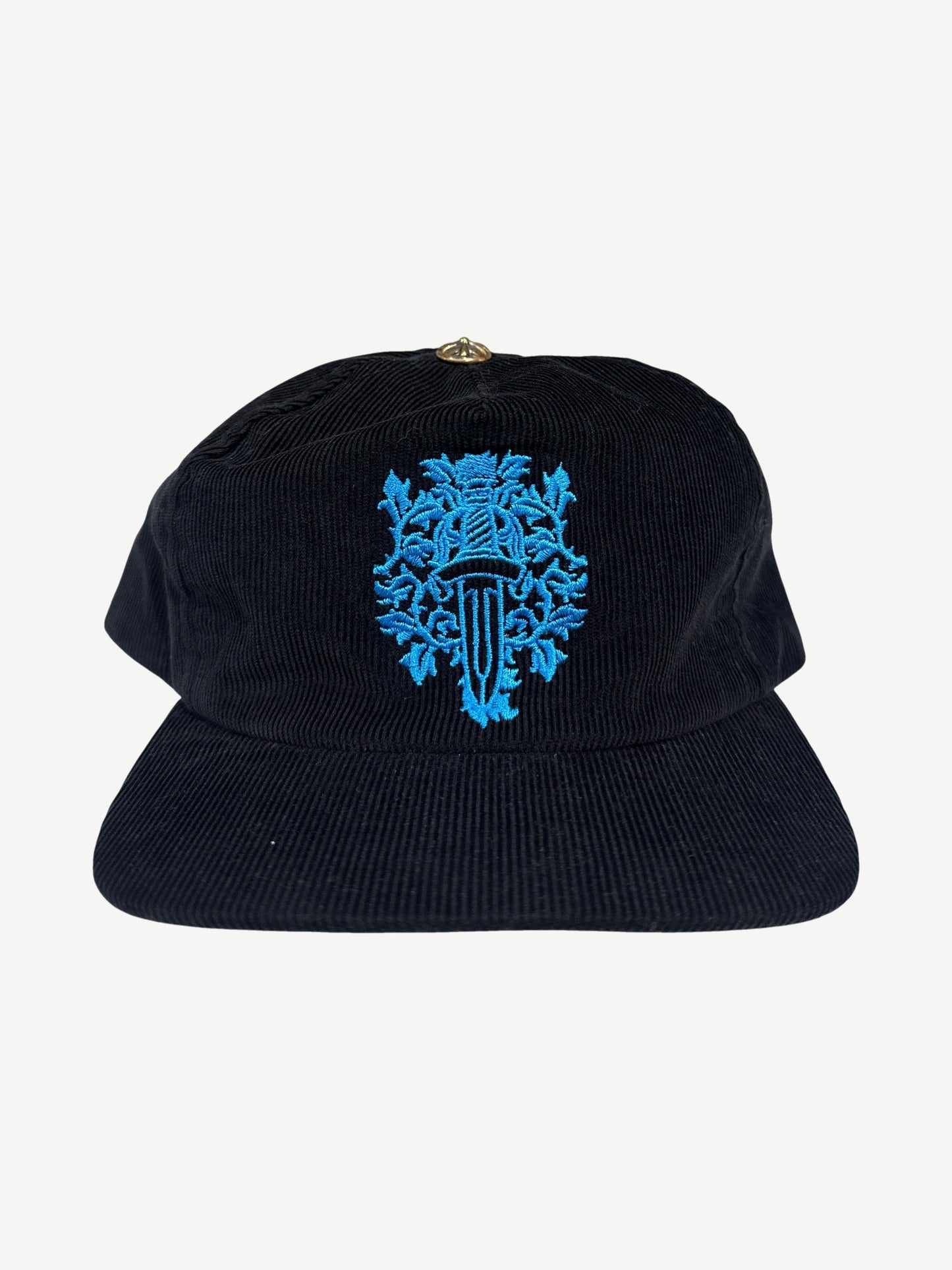 Chrome Hearts black corduroy dad hat with embroidered blue floral dagger crest on the front panel.
