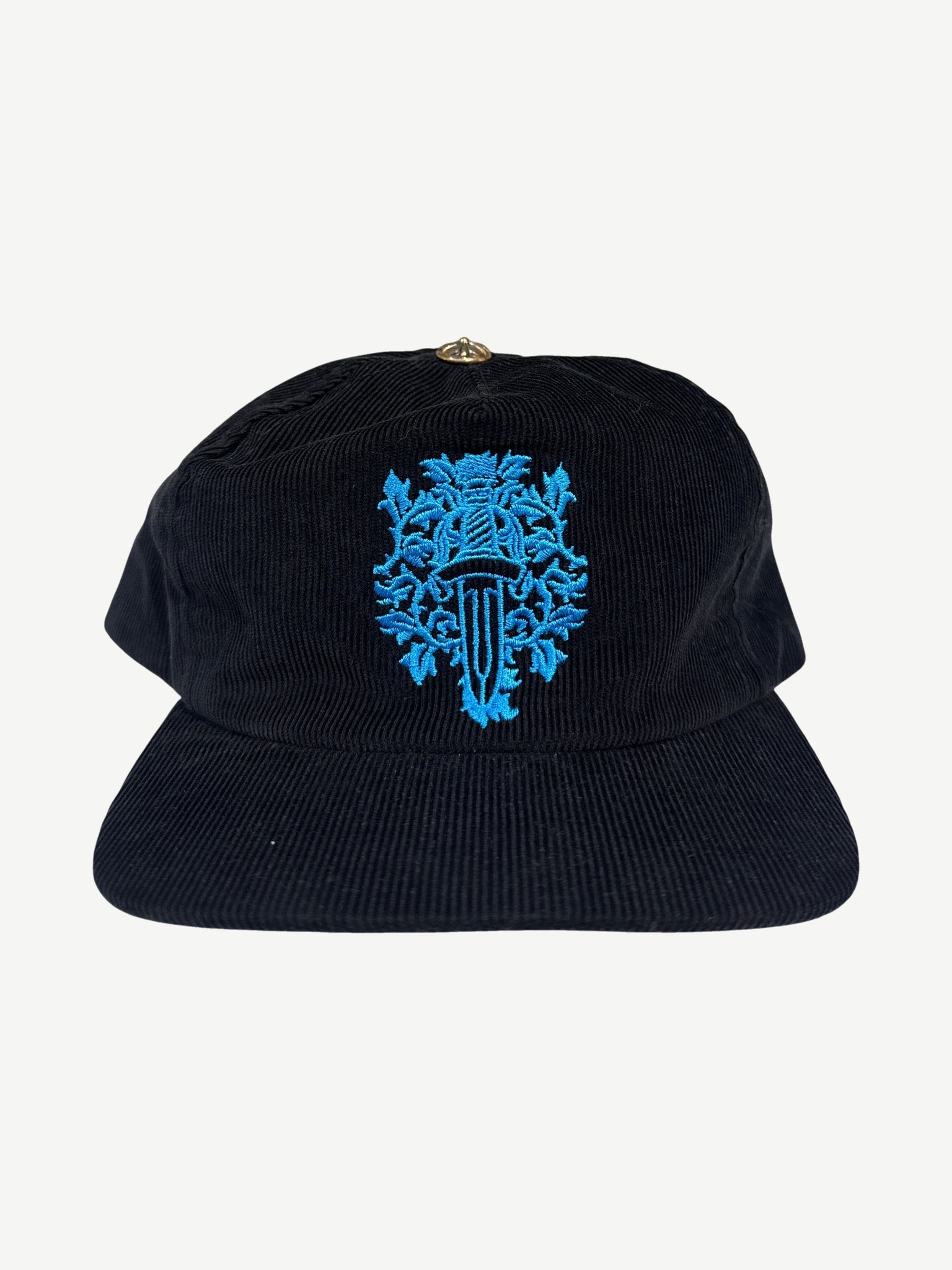 Chrome Hearts black corduroy dad hat with embroidered blue floral dagger crest on the front panel.