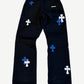 Chrome Hearts black cross patch jeans back, blue and white leather crosses across pockets and down both legs.