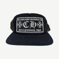 Chrome Hearts Hollywood trucker hat with black camo crown, white mesh back and embroidered CH front patch.