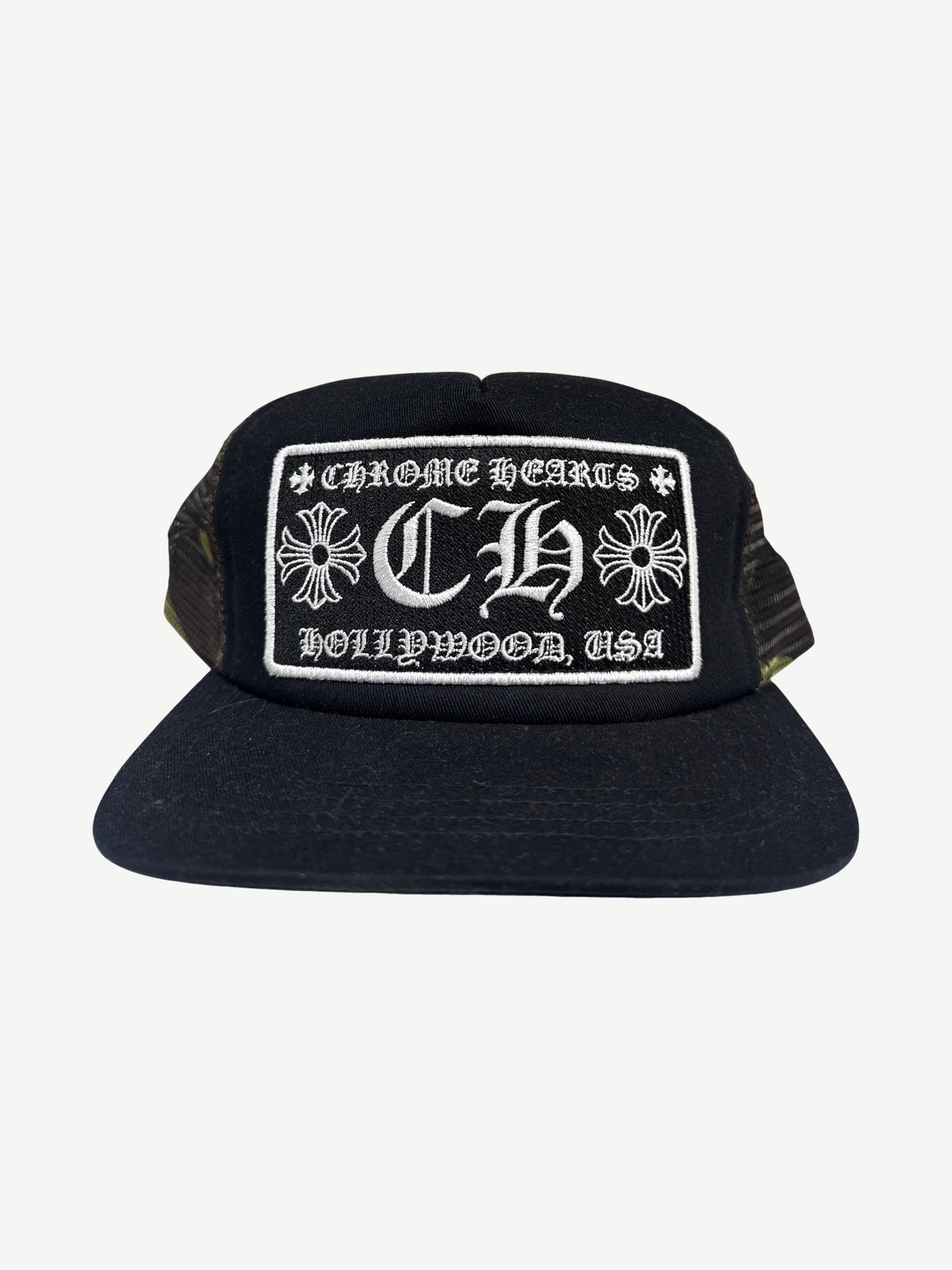 Chrome Hearts Hollywood trucker hat with black camo crown, white mesh back and embroidered CH front patch.