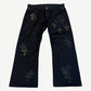 Chrome Hearts black chino pants front with scattered leather cross patches and silver CH button hardware