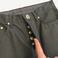 Chrome Hearts black jeans close-up of silver dagger button fly and Chrome Hearts gothic waistband lining